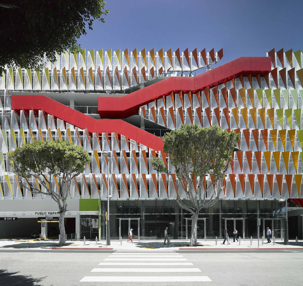 Completed City of Santa Monica 4th Street Parking Structure, the first LEED-certified parking garage in the US, with its perforated orange, green, and yellow facade and red diagonal stair.